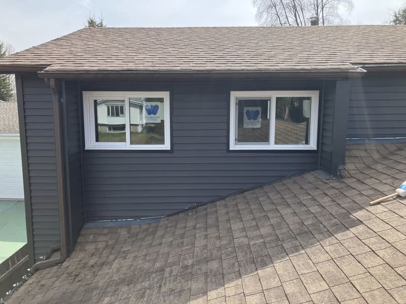 Two new white slider windows on a charcoal dormer