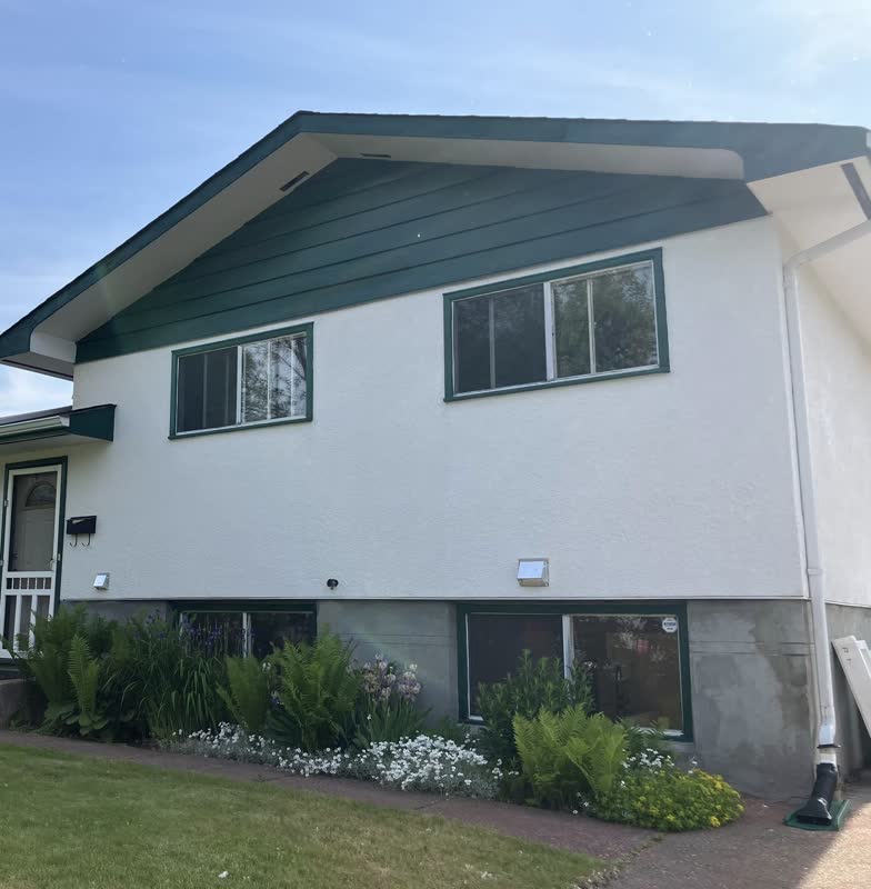 Classic white-and-green Prince George home with new green-trim windows