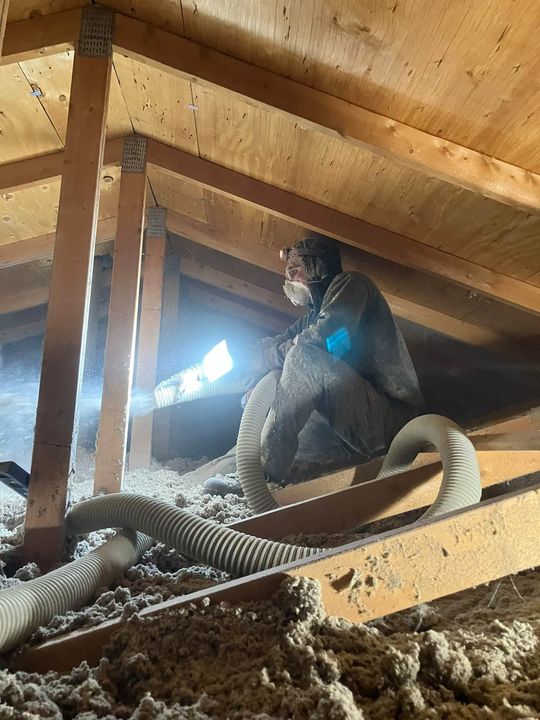 Attic tech blowing cellulose insulation