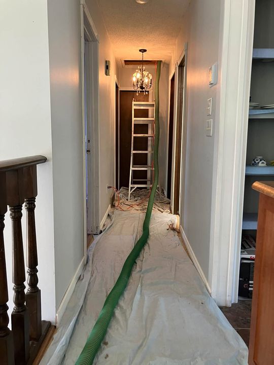 Hose run along a protected hallway floor