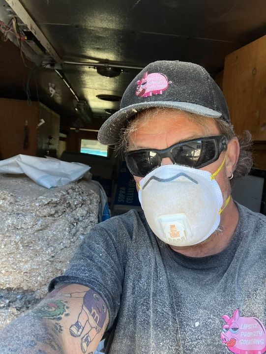 Attic tech in a dust mask
