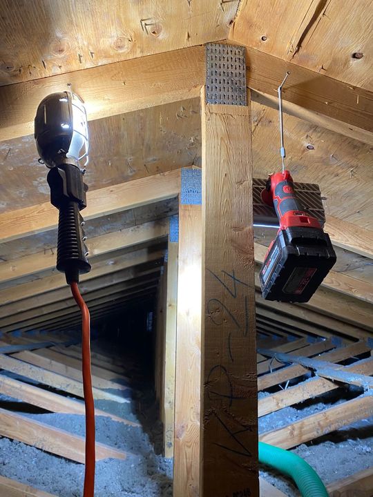 Work light hanging between the attic trusses
