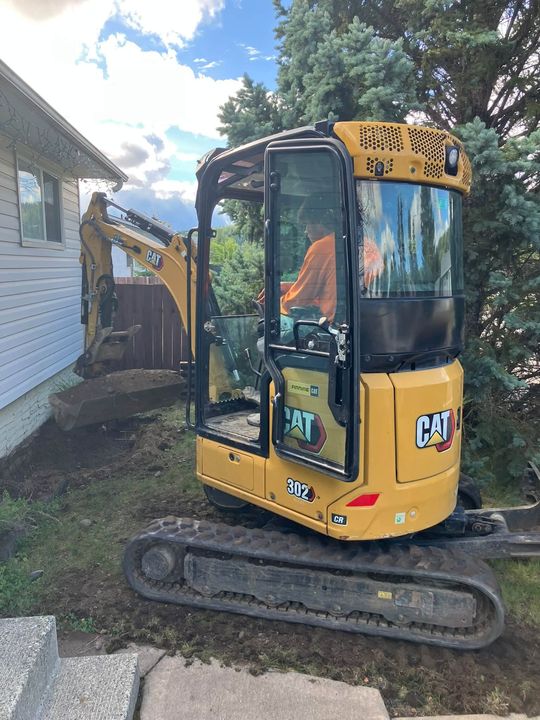 Mini excavator beside the house