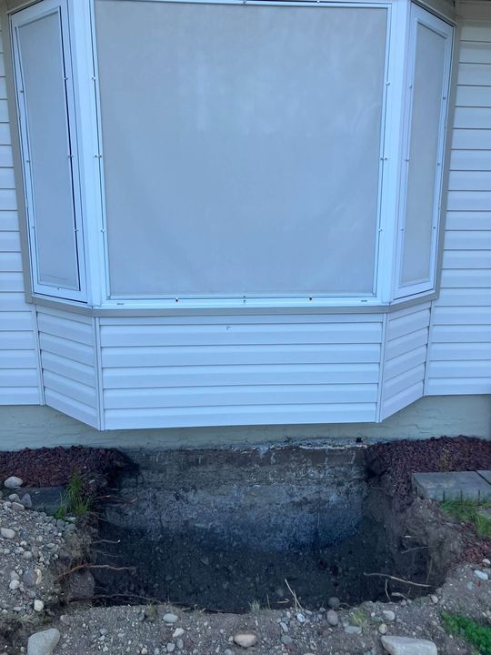 Excavated pit below the bay window