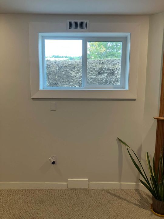 Finished egress window in a basement bedroom