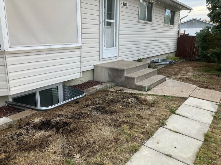 Two new window wells along the front of the house