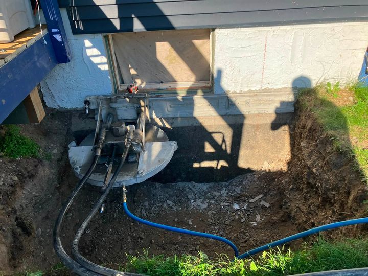 Wall saw cutting the concrete foundation to enlarge the opening