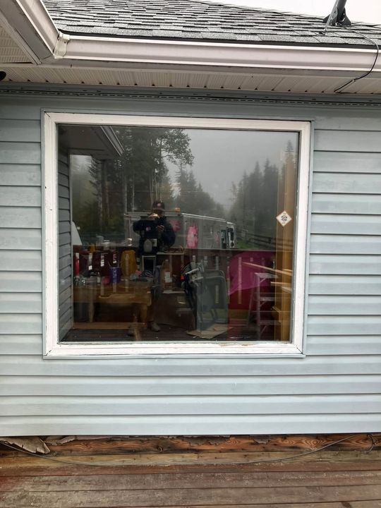 Finished patio door on a light-blue rural home