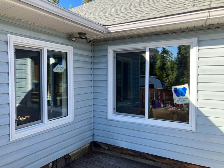 Two new windows at the corner of the light-blue home