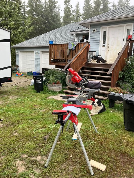 Job site set-up with a mitre saw in front of the rural home