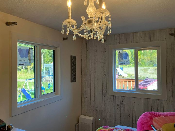 Two new windows in a room with a chandelier