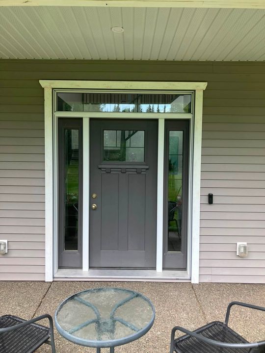 Finished entry door with sidelites and transom from the porch