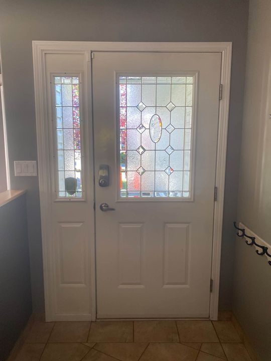 New white entry door with decorative glass, from inside