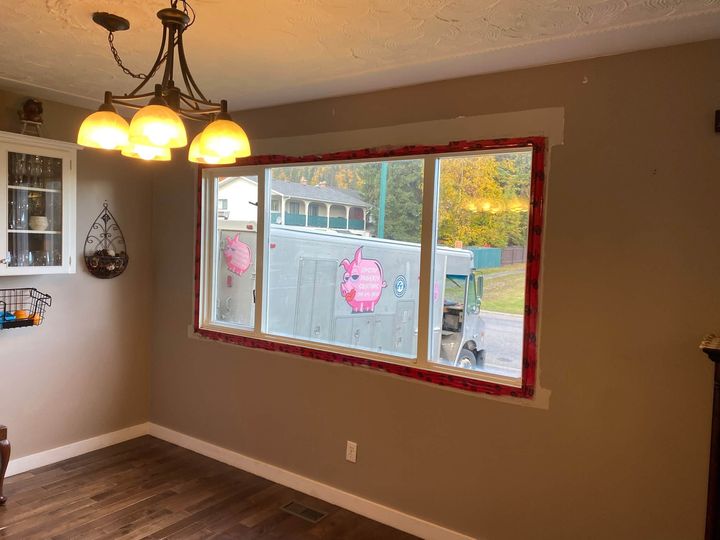 New dining room picture window freshly installed, protective tape still on