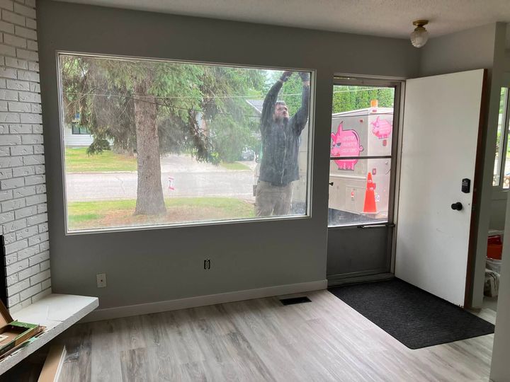 Living room with the new window, installer working outside