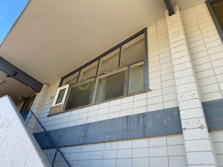 Long band of windows on the rental building with the new casement