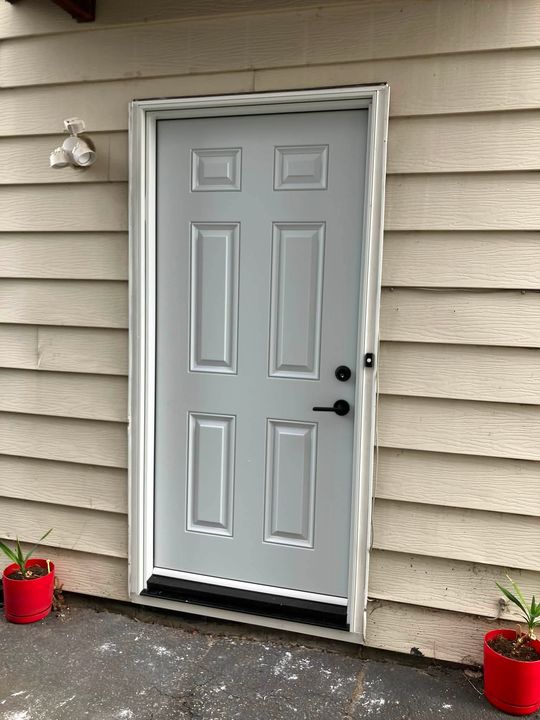 After: New six-panel steel entry door installed