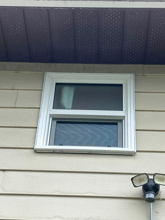 New bathroom window on beige siding